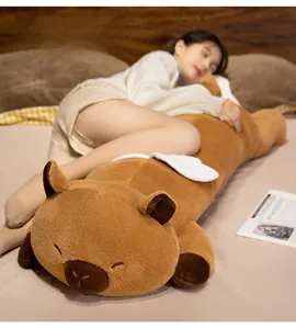 Detail view of the soft brown long capybara plush pillow being hugged in a cozy bedroom
