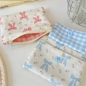 Detailed view of assorted canvas card wallets with floral prints and bow patterns