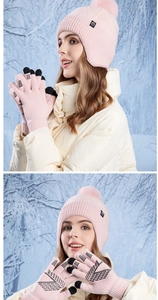 Pink winter knit set with pompom earflap hat and touchscreen gloves in a snowy forest
