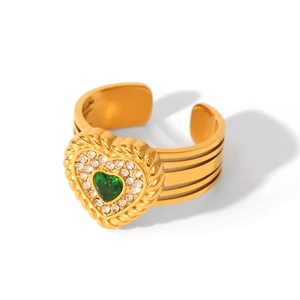 Detailed macro view of gold heart ring with green gemstone and textured band