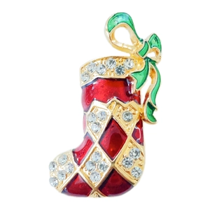 Close-up of a Christmas stocking brooch with red enamel, gold plating, and rhinestones