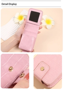 Detailed macro view of pink crocodile-pattern PU leather pouch with built-in mirror