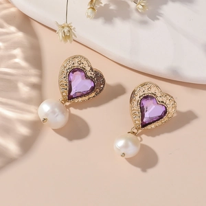 Elegant heart-shaped gold earrings with purple gemstones and hanging white pearls