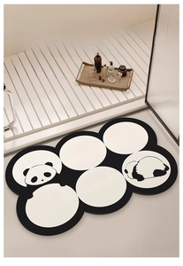 Detailed top view of a panda-shaped absorbent bath mat with a modern 6-ring design