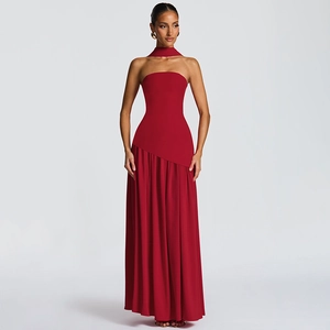 Detail of red strapless maxi dress with matching neck scarf and elegant flowing silhouette