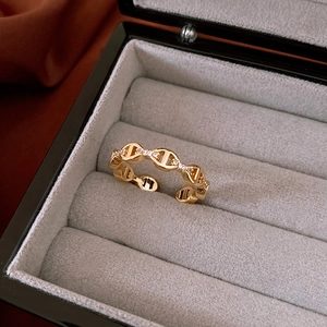 Detail of gold plated open ring with pig nose link design and micro paved white zircons
