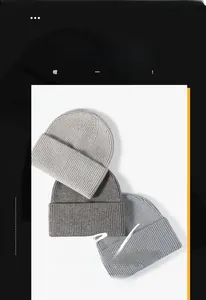 Close-up of thick ribbed knit beanies in grey and blue with folded cuff for winter warmth