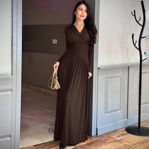 Detail of dark brown V-neck maxi dress with cinched waist and pleated flowing skirt