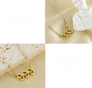 Detail view of gold 333 and 999 number pendants crafted from durable titanium steel