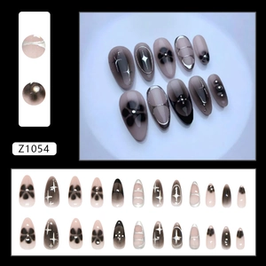 Black and pink gradient press-on nails with silver star and floral patterns