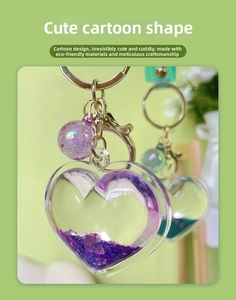 Close-up of heart-shaped liquid quicksand keychain with purple glitter and laser ball charm