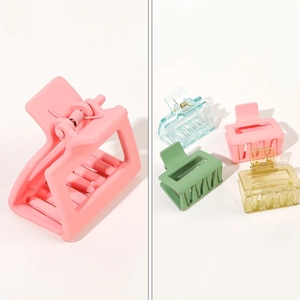 Detail view of colorful matte and translucent rectangular hair claws with metal spring