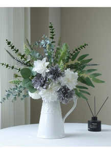 Detailed view of white and gray silk dahlias in a textured ceramic vase for home decor