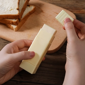 Vertical rotating white butter spreader stick for bread and baking in kitchen setting