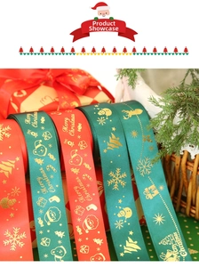 Macro detail of red and green satin Christmas ribbons with gold foil holiday patterns