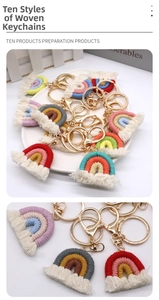 Detail of multi-colored hand-woven cotton rainbow keychains with tassels and golden hooks