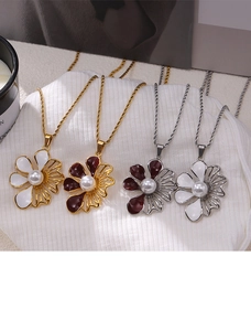 Dettaglio dei ciondoli a fiore vintage con perle nei colori bianco e rosso vino