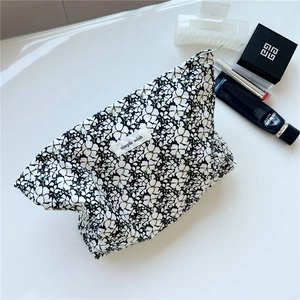 Floral cotton makeup bag with 'simple wish' label and secure zipper closure for storage