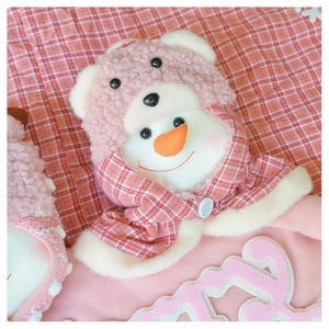 Close-up of plush Christmas snowman with pink plaid bear hood and lamb wool texture