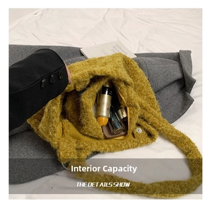 Close-up of the plush green tote bag interior showing large capacity and magnetic buckle