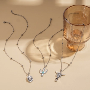 Western style silver necklace set with cow skull cactus and cowboy hat pendants