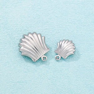 Detailed view of silver stainless steel shell pendants with metallic luster and jump rings