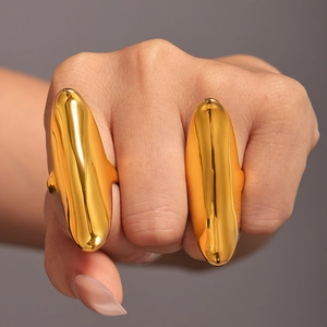 Polished gold irregular long open rings on model fingers against gray background