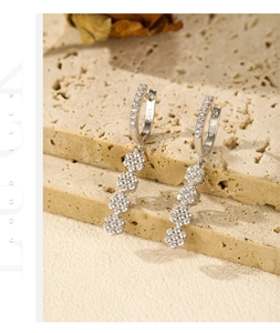 Macro detail of S925 hallmark on silver floral earrings with sparkling zircon stones