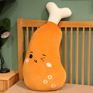 Detail of cute embroidered expression on a plush fried chicken leg pillow