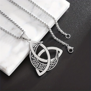 Detailed close-up of vintage Celtic Triquetra and moon pendant on a steel box chain