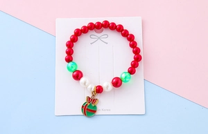 Detail of Christmas beaded bracelet with festive red white pearls and green ball pendant