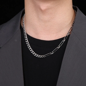 Chic silver Cuban and paperclip chain necklace styled on model with a minimalist look