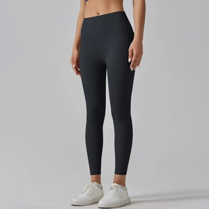 Detail of high waisted black yoga leggings showing seamless fit and tummy control