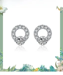 Close-up of S925 silver round stud earrings featuring pavé setting and central cubic zirconia