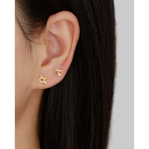 S925 silver gold zodiac earrings with tiny zircon stones on model's earlobe