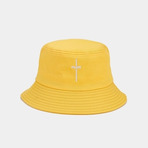 Close-up of bright yellow cotton canvas bucket hat featuring white PEACE embroidery