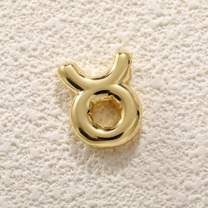 Macro shot of 18K gold plated Taurus zodiac bubble pendant for DIY jewelry making