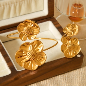 Golden asymmetrical floral jewelry set with stainless steel ring and open cuff bracelet