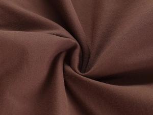 Detail shot of the stretchy dark brown knitted fabric with soft textured spiral folds