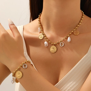 Gold beaded necklace and bracelet set with irregular pearls and religious medallions