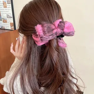 Pink and grey velvet bow hair claw clip for elegant women styling on long brown hair