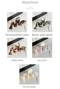 Detail of colorful wavy acetate hair claws in various marble and tortoiseshell patterns