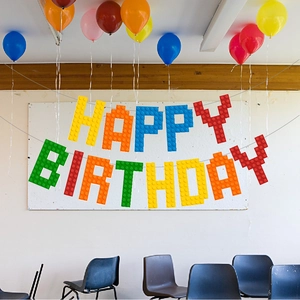 Colorful building block style Happy Birthday banner for pixelated party theme decoration
