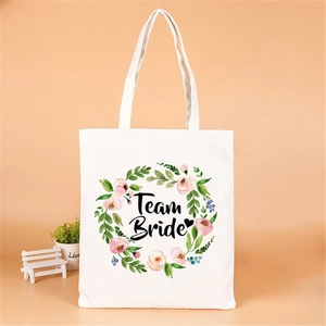 Close-up of Team Bride canvas tote bag with floral wreath and pink flower design