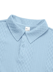 Close-up of light blue polo collar with waffle texture and Size L polyester label