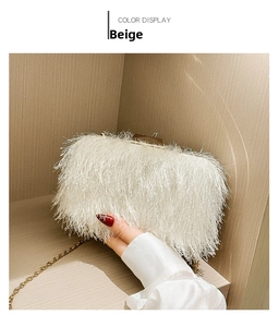 Detail of beige acrylic evening clutch featuring long fringe tassels and gold chain strap