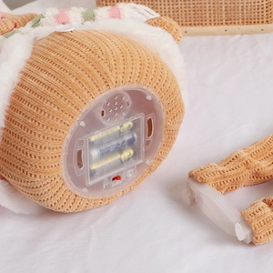 Telescopic gingerbread man plush with bottom battery compartment and power switch details