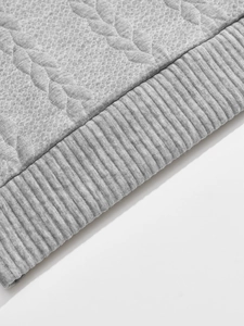 Macro detail of men's gray quilted sweatshirt fabric showing rib knit hem texture
