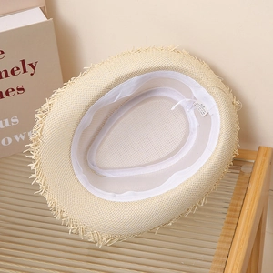 Close-up of internal sweatband and paper fiber label inside the straw sun hat
