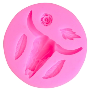 Detail of pink silicone mold featuring bull skull and feathers for aromatherapy candles